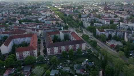 Slide-and-tilt-up-reveal-of-residential-urban-neighbourhood.-Various-houses-along-straight-wide-street.-View-against-bright-sky.-Berlin,-Germany