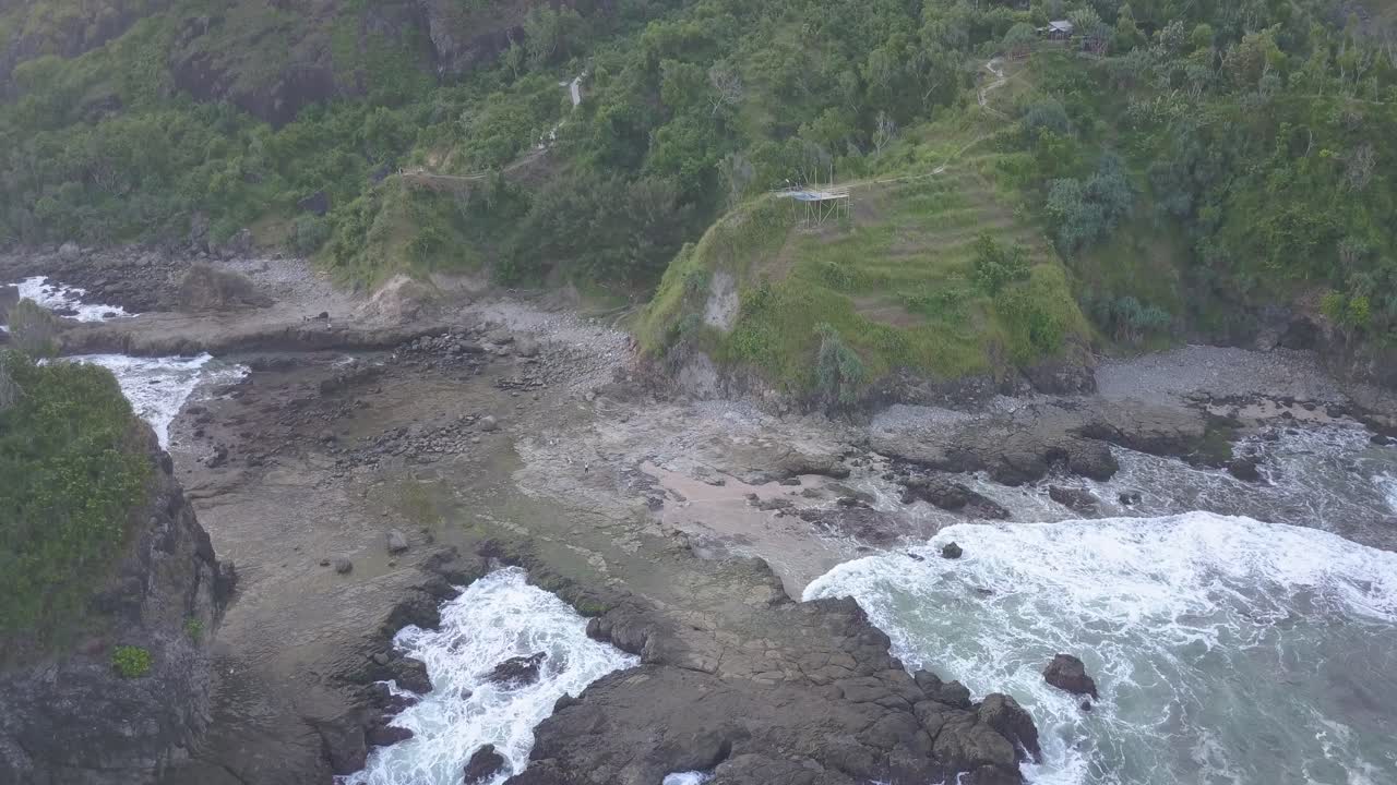 Watu Lumbung Beach in Gunungkidul, Yogyakarta. A beach with unique large rocks and corals. The waves crash against each coral.
