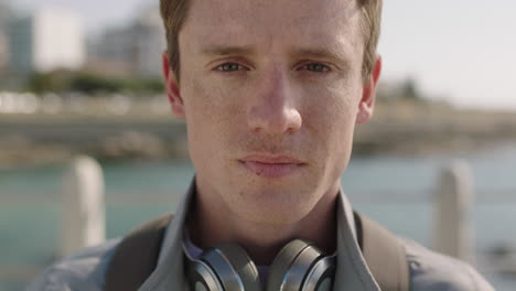 close-up-portrait-of-red-head-teenager-man-looking-serious-on-sunny-beachfront