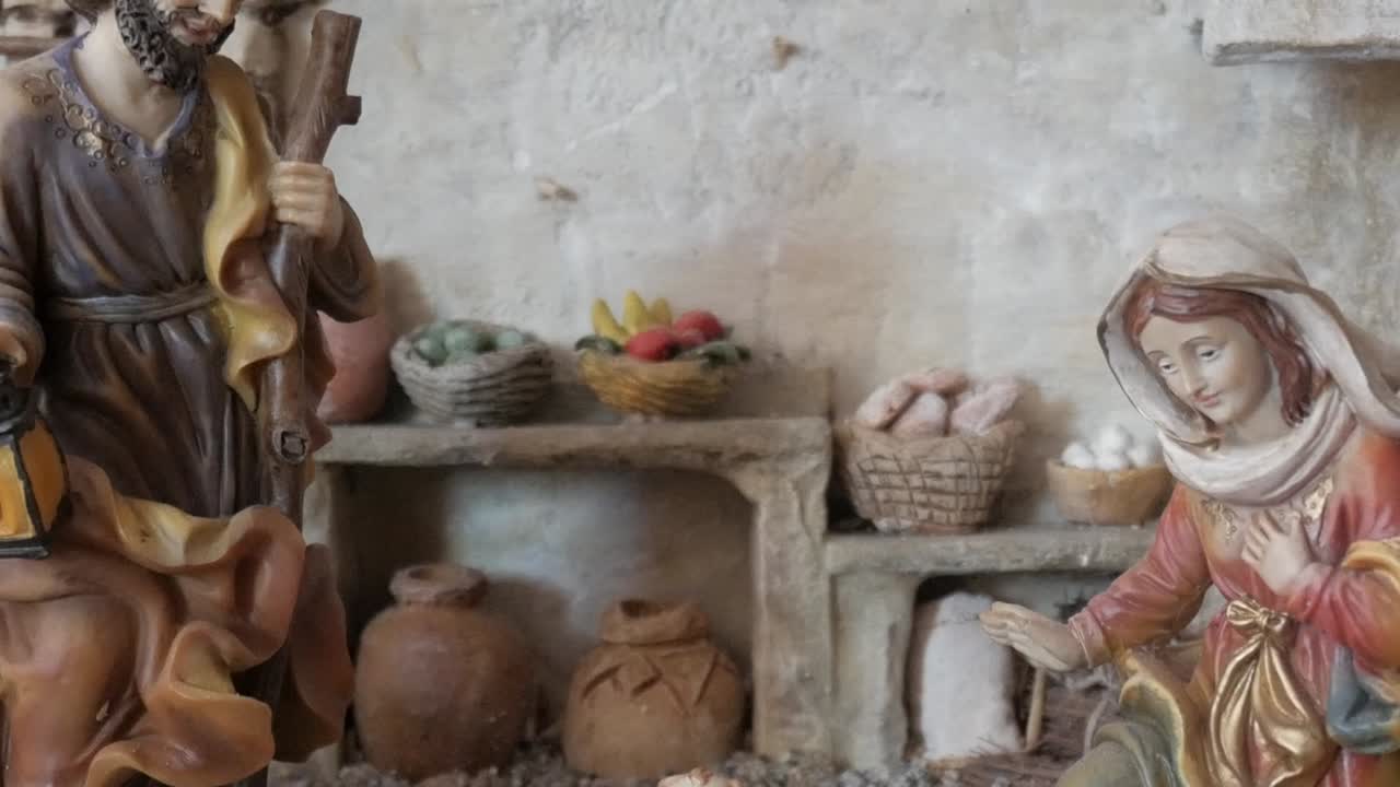 A nativity scene indoors with detailed figurines and baskets, depicting calm and reverence