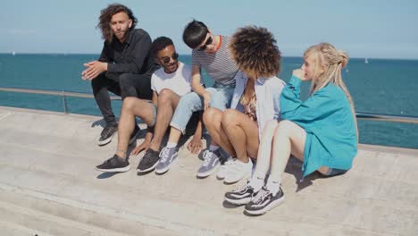 trendy young friends chilling on seafront