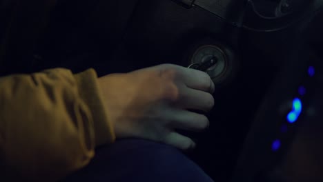 Man-turning-ignition-key-in-car.-Close-up-view