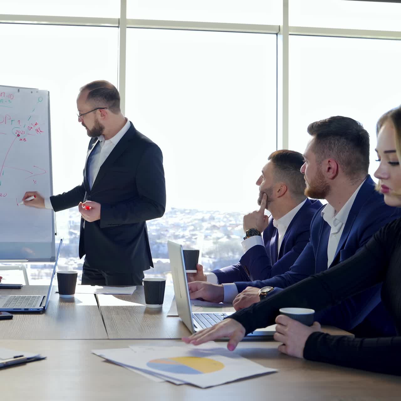 Successful meeting of business people, discussing new business ideas, using diagrams, sitting together. Meeting of business partners at the conference on business development