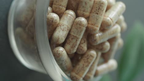 close-up of numerous natural supplement capsules in a clear bottle