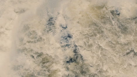 aerial view of white water rushing down river and waterfall in slow motion 40fps