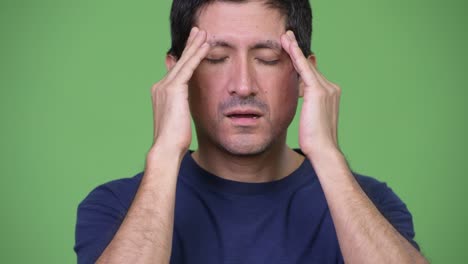 stressed hispanic man having headache