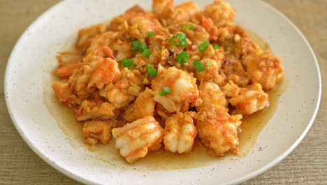 stir-fried shrimps with garlic and shrimps paste on whie plate