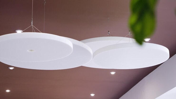 Slow rotating shot of circular ceiling panels hanging in a hotel entrance