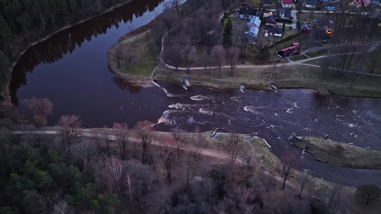 Aerial view of Gauja Rapid in Valmiera, Latvia, dark river bend from above