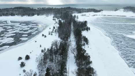 Dollying-and-tilting-down-to-a-snowy-side-road-during-a-lakeshore-flurry