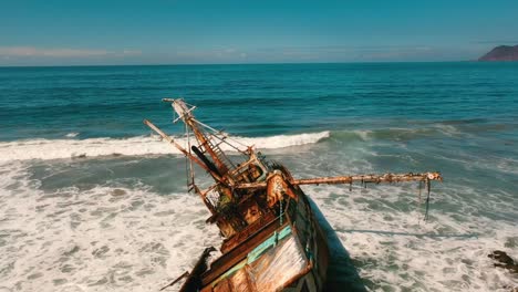 aerial shot of a sunken ship in the pacific ocean in the summer on a blue sky day