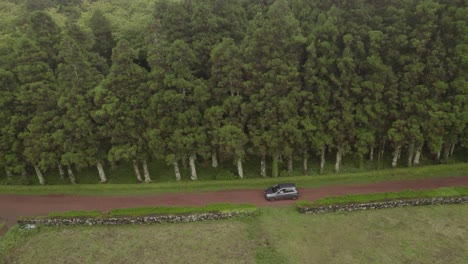 drone view of car driving on gravel road - parque florestal das sete fontes