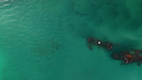 aerial: top down view of shipwreck oil spill in ocean
