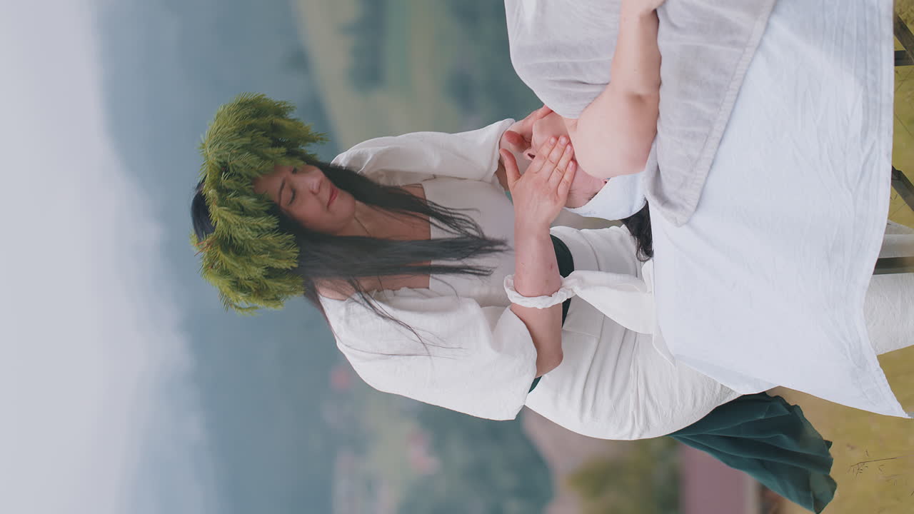 terapeuta mujer médico hace mujer relajante spa masaje facial con las manos al aire libre en el campo de las montañas