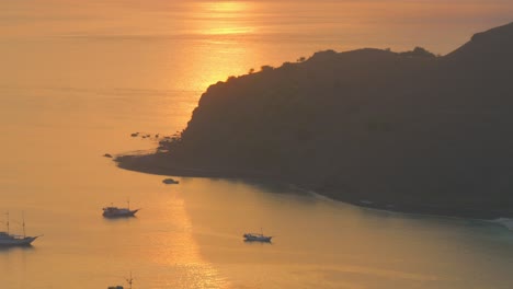 silhouette of fishing boats moored at sunset in padar island in indonesia