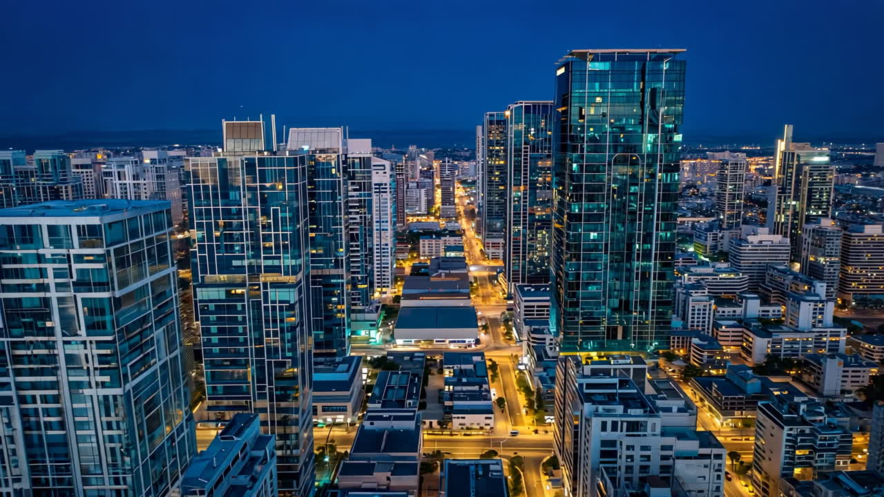 Nighttime Aerial View of a Modern City with Illuminated Skyscrapers