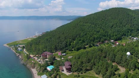 aerial view of lakeside town and mountains