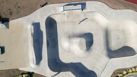 aerial top down view of skate track with a boy training