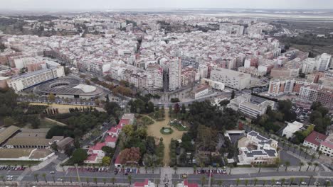 aerial orbiting view muelle gardens near the bus station with huelva cityscape in background, spain