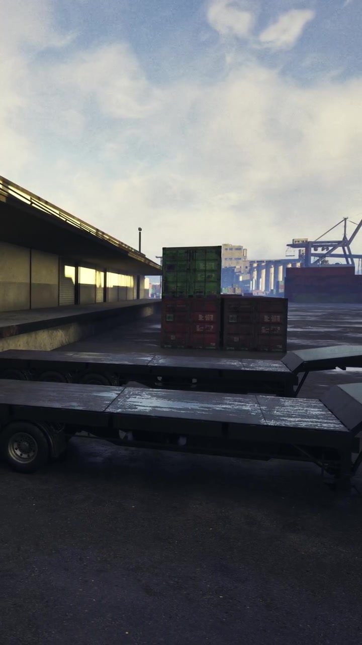Cargo containers stacked at a loading dock during the day in a shipping yard