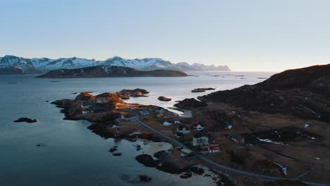the fiskenesholmen town outside of tromsø, norway pan up left aerial drone shot on a sunny winter day.