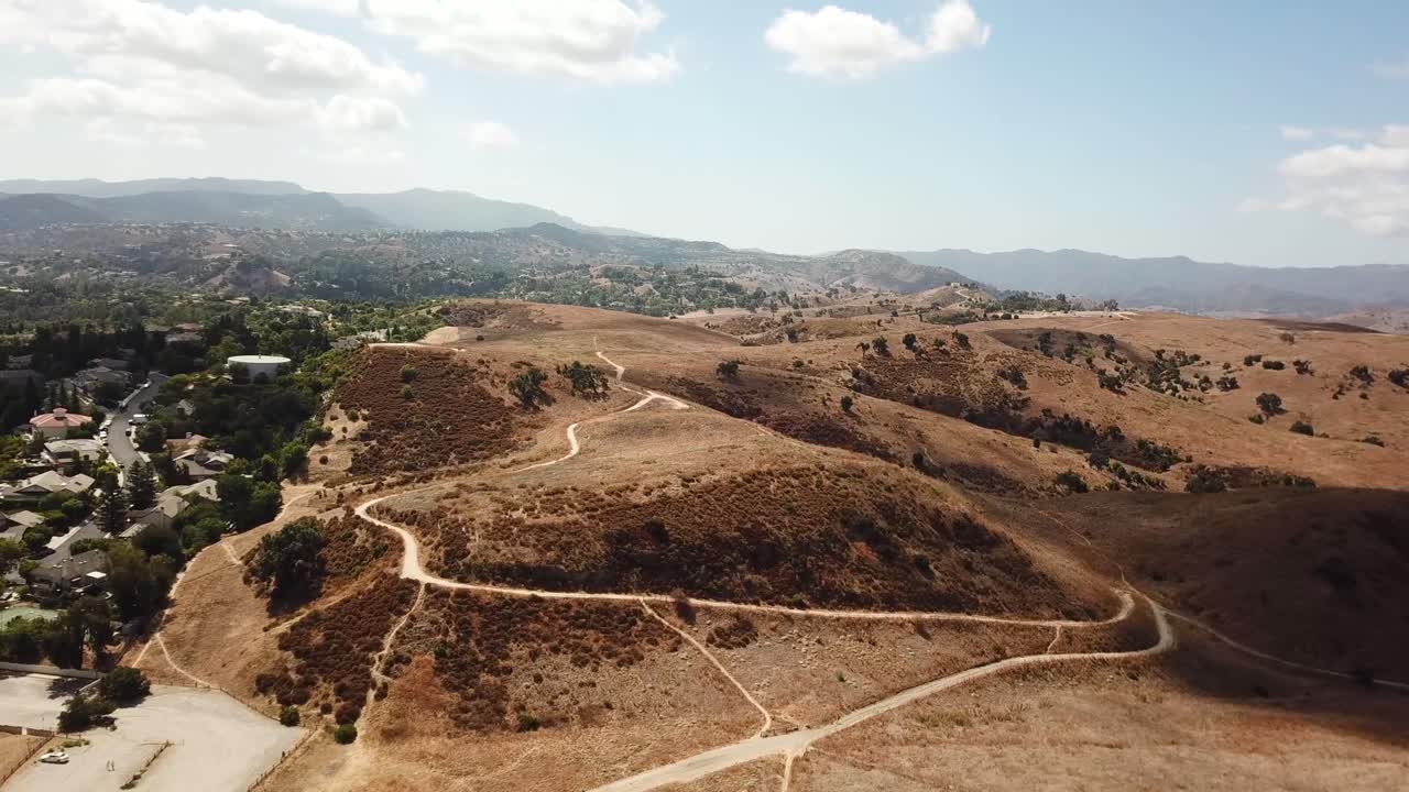 Sandy Mountain landscape with roads in suburb of Hidden Hills City. Suburb neighborhood with noble houses and villas. Aerial panorama wide shot. CA, USA.