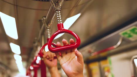 passengers grip handles on a moving train