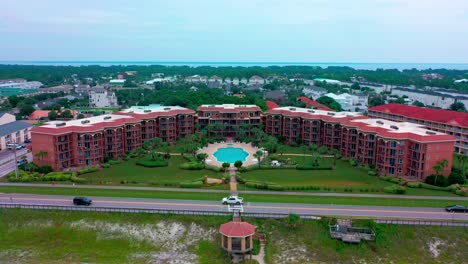 High-aerial-view-flying-towards-the-center-of-the-Mediterranea-Condominium-and-resort-in-Miramar-beach-near-Destin-Florida