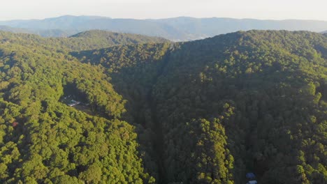 4K-Drone-Video-Flying-Above-Trees-Along-Mountain-Road-in-Smoky-Mountains-near-Asheville,-NC-on-Foggy-Morning