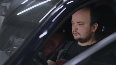 male mechanic uses a tablet computer with an augmented reality diagnostics software. specialist inspecting the car to find broken components inside. male uses laptop for diagnostics vehicle