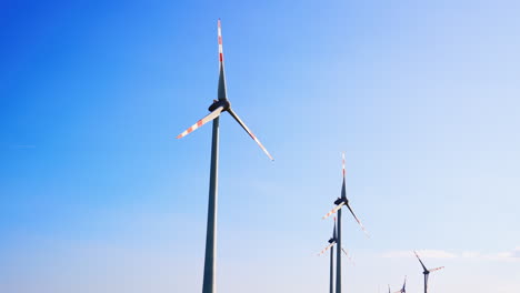 wind turbines in clear skies. machines harnessing wind energy stand tall against a clear blue sky, showcasing renewable energy innovation in action