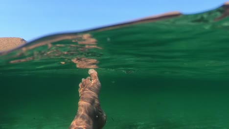 feet swimming in the mediterranean sea