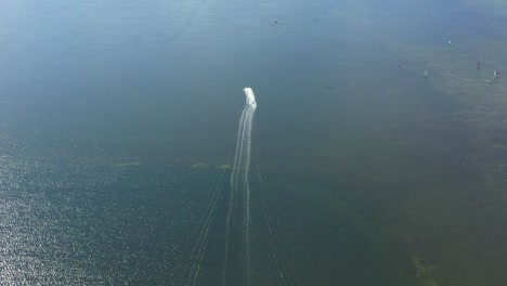 water scooter move away to beach, aerial wide angle shot