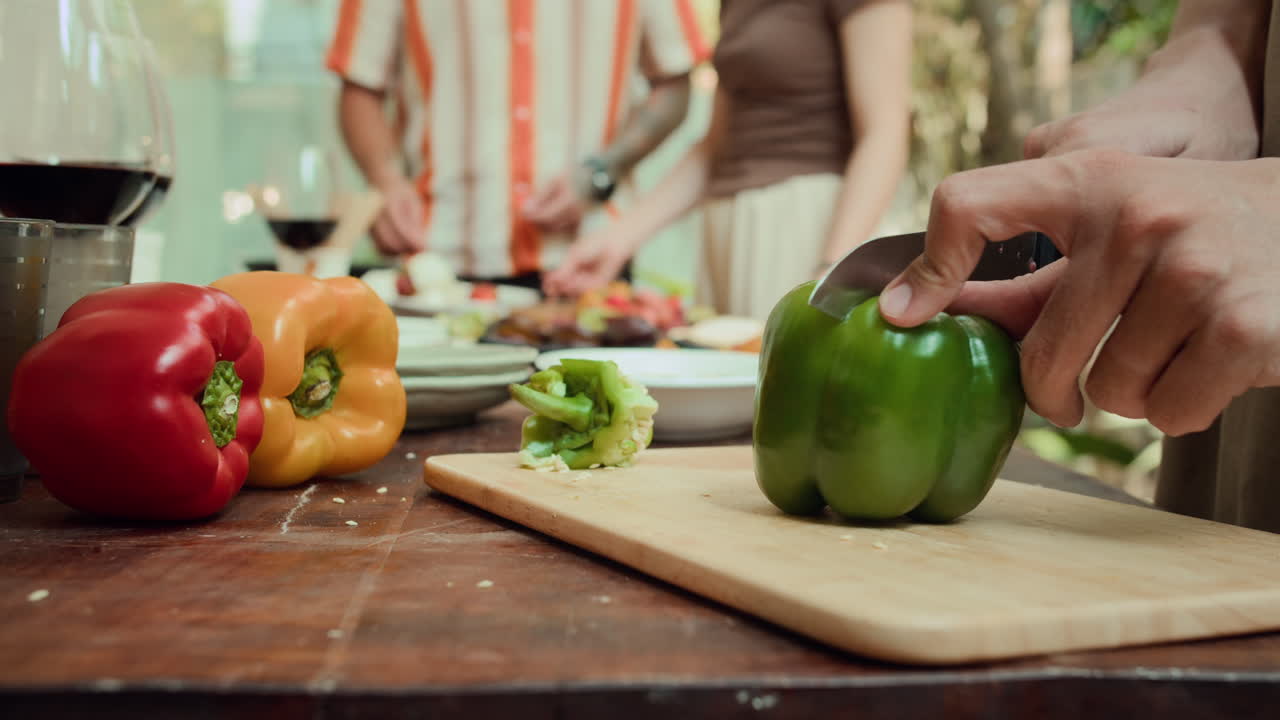 Anonymous Man Cutting Bell Pepper during Barbecue Party