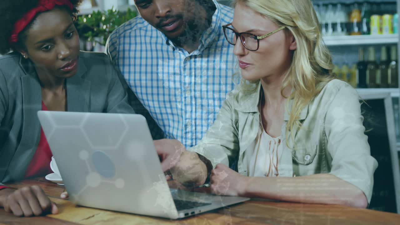Animation of scientific data over diverse female and male coworkers using laptop