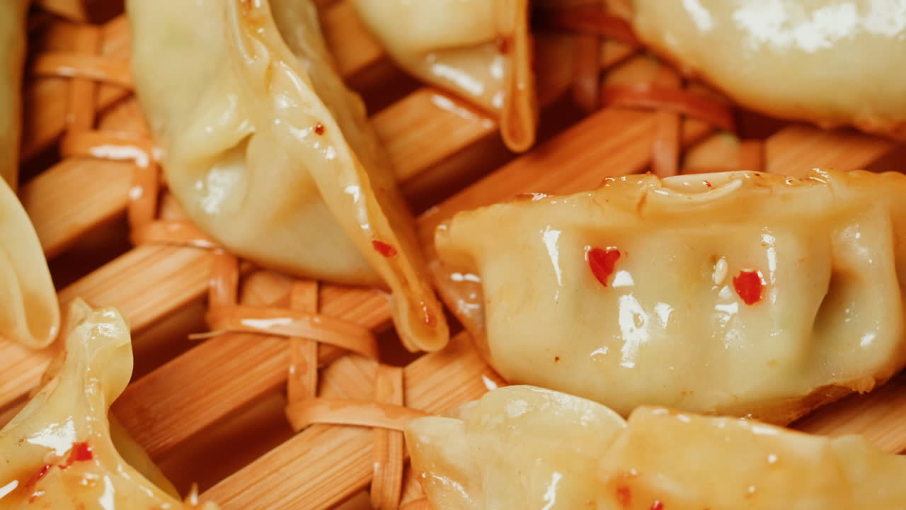 Golden Fried Dumplings with Chili Flakes on Bamboo Steamer