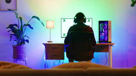 a back-shot view of a young gamer playing games