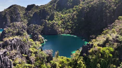 drone shot of beautiful twin lagoon, rocky hills and calm waters coron, philippines
