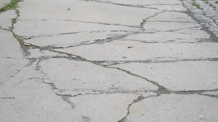 Close-up of a cracked concrete road