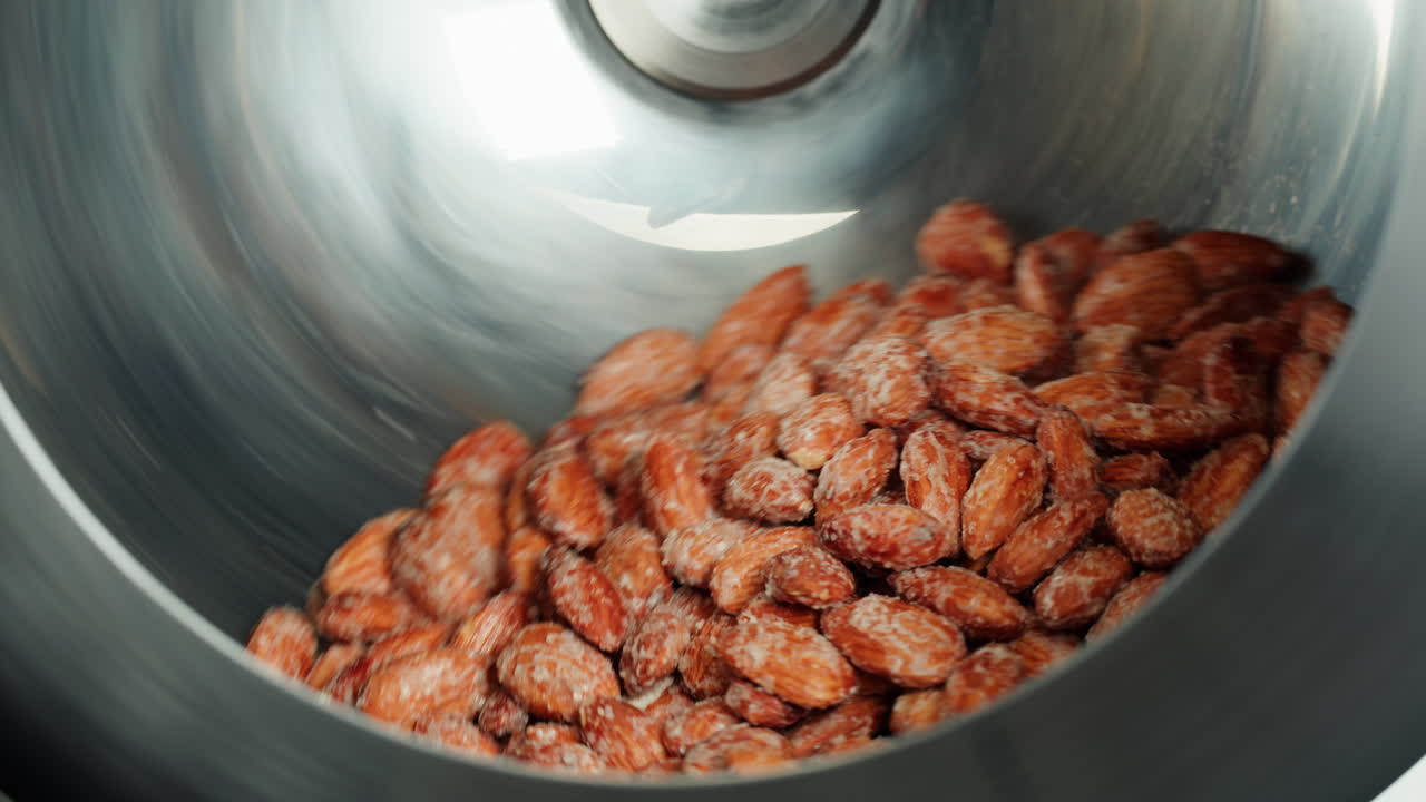Almonds being processed in a metal container