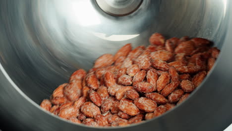 almonds being processed in a metal container