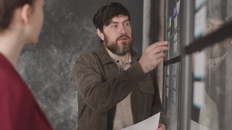 caucasian man talking to coworker