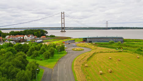 Aerial-drone-captures-Humber-Bridge,-the-12th-largest-suspension-span,-elegantly-spanning-River-Humber,-connecting-Lincolnshire-to-Humberside-amidst-constant-traffic