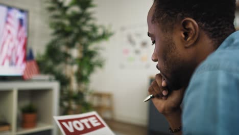 video of man watching tv and holding vote document