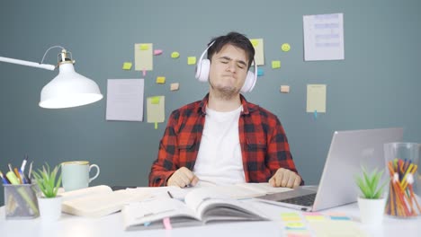 happy male student listening to music.