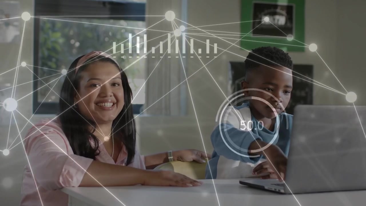 Woman leaning, guiding boy typing on laptop in home education while HUD overlay showing graphs