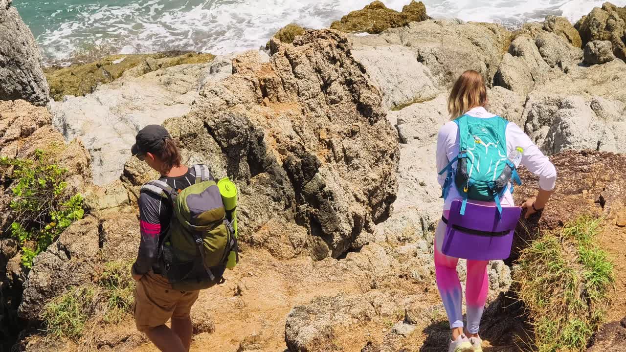 Hikers on a rocky coastal path