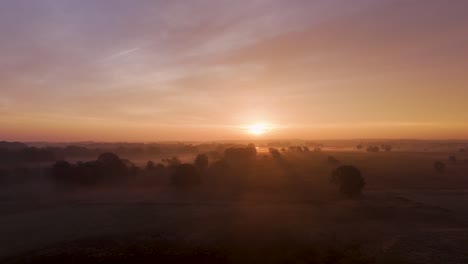 sunrise over a misty landscape