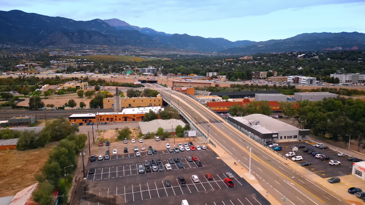 Approaching the parking lots in the scenery of a lively city. View on the roads with hectic traffic. Colorado-Springs, Colorado, USA