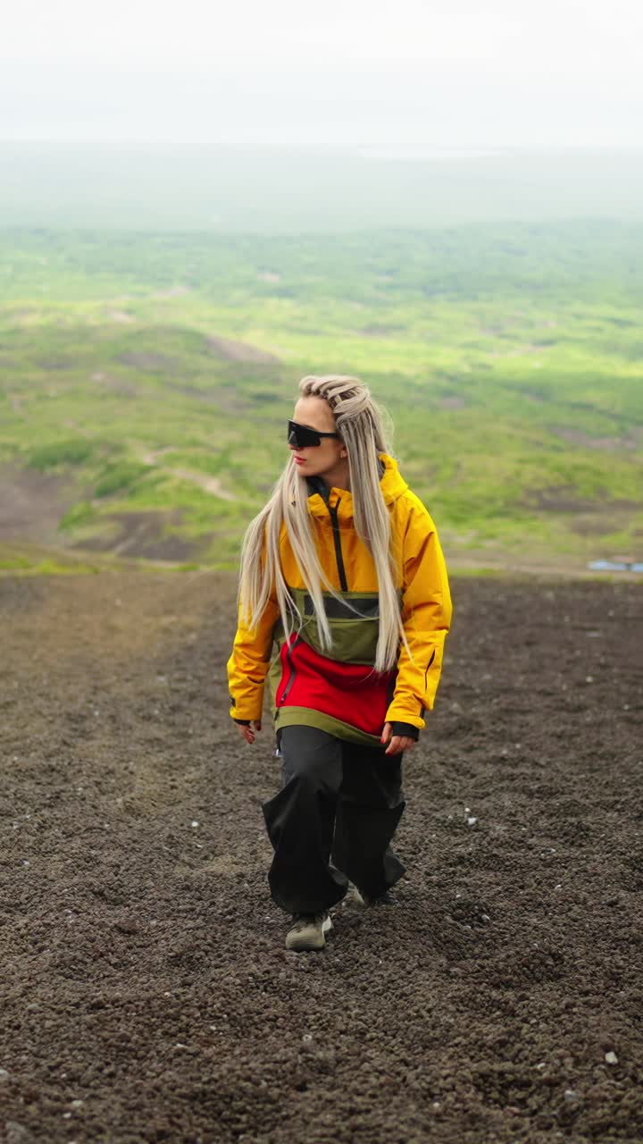 Adventurous Woman Walking Uphill on a Mountain Slope